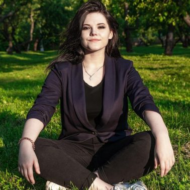 portrait-young-woman-sitting-grassy-land-park_1048944-11898263